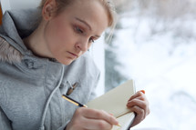 Young woman writing in her journal