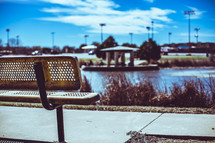 park bench with a view of a pond 