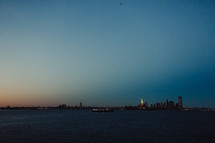 distant view of the Statue of Liberty from water at night