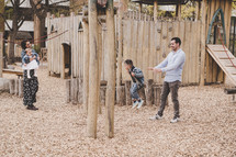 family playing on a playground 