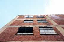 looking up at the exterior of a brick building 