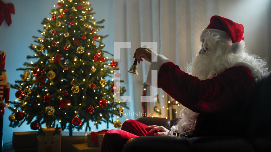 Santa Ringing the bell under Christmas tree