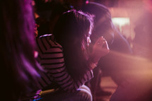 praying teen girl at a worship service 
