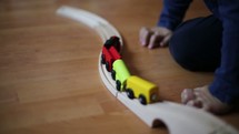 boy child playing with a toy train 