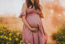 a pregnant woman with her hand on her stomach 