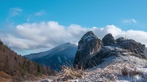 Between winter and spring, rock and snow in the foreground, timnelapse