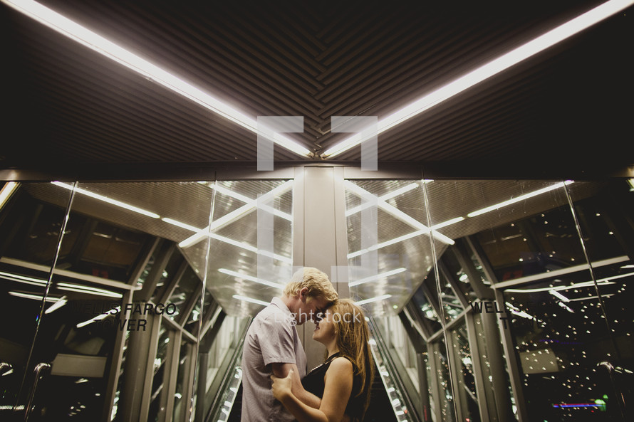 Couple holding each other  inside a building