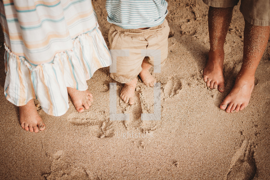 children with feet in the sand 
