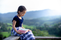 a school girl reading a Bible 