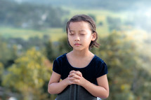 praying child outdoors 