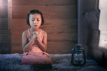 a girl kneeling in prayer 