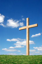 wood cross against a blue sky 