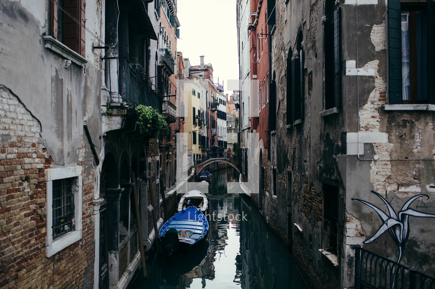 gondolas in a narrow canal in Venice 