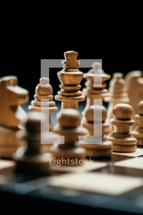 chess pieces on wooden chessboard before party competition. Board strategy game. Teamwork, success business, intelligence sport concept.