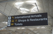 LONDON, UK - CIRCA JUNE 2018: International arrivals, shops and restaurants, toilets sign at Stansted Airport