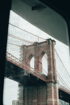 view of a bridge in New York City through a window 