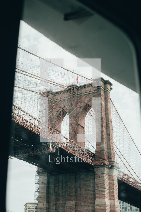 view of a bridge in New York City through a window 