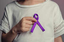 wearing a purple ribbon 