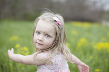 A little girl in a field of flowers.