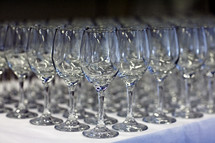 Empty wine glasses_ lined up on table 