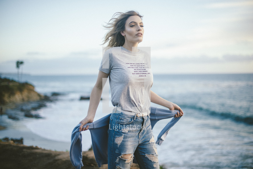 woman wearing a John 3:16 t-shirt on a beach 