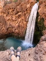 sandals and a view of a waterfall 