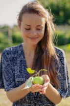 a woman holding an apple 