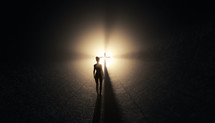Young woman in dark tunnel looks towards light opening with cross in the background.