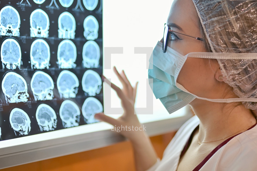 Young Female Doctor Examine Mri Picture