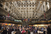 people eating in a crowded food court 
