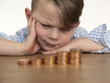 a boy child counting his money. 