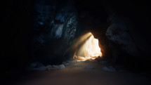 Resurrection. Inside view of a cave with light coming out of the entrance.