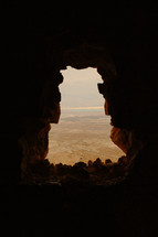 view from a cave overlooking a canyon 