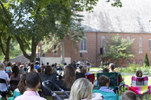 Church service, congregation outside in the summer