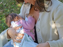 Young brunette mum breastfeeding her baby