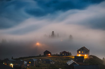 Misty and foggy mountain village in the evening