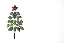 simple Christmas tree of leaves and string on a white background with copy space 