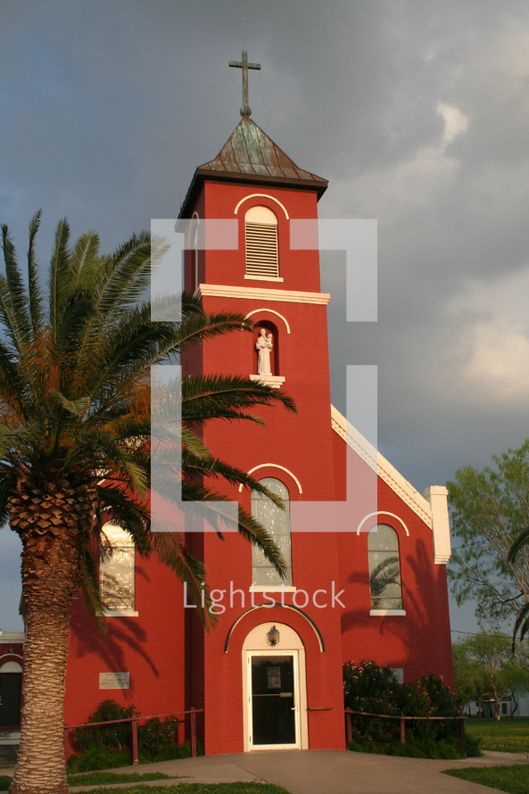red church and palm tree 