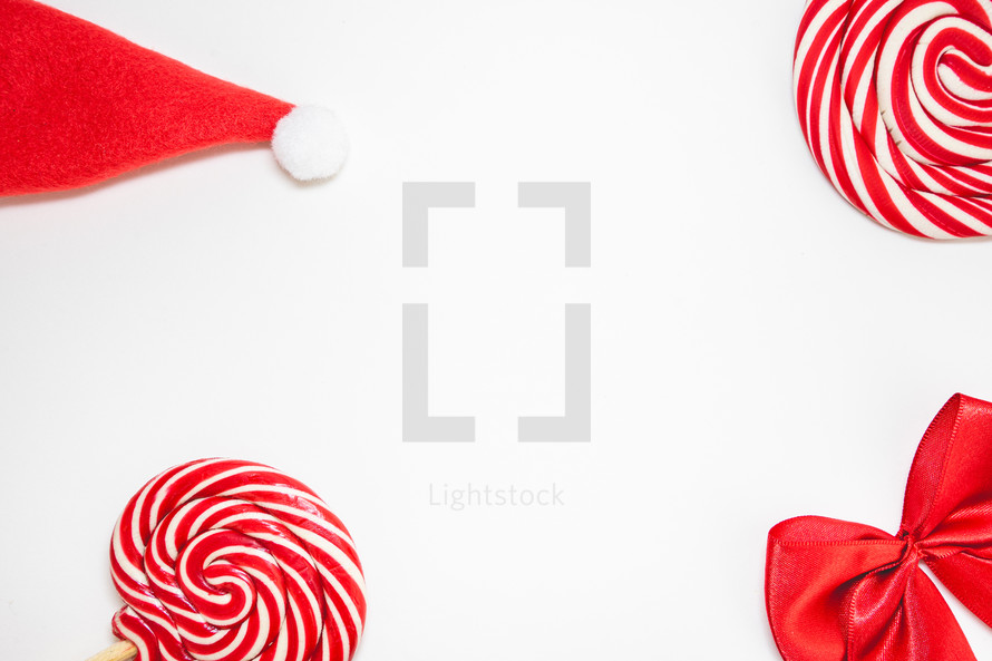 Flatlay of some red Christmas decoration, on a white background. Background for Christmas.