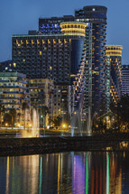 Colored buildings and fountains in the evening