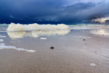 sea foam on a beach shore 