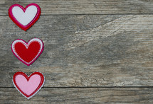 heart shaped cutouts on wood background 