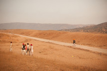 man walking on a dirt road and mountain in India 