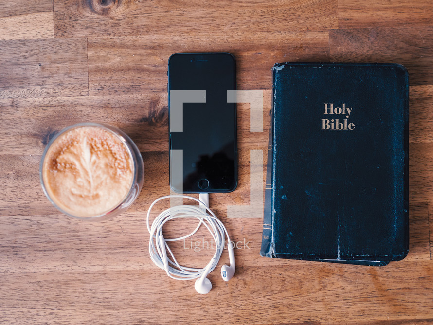 coffee and Bible with earbuds 