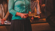 people holding hymnals at church 