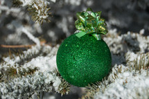 Christmas ornament and snow on pine 