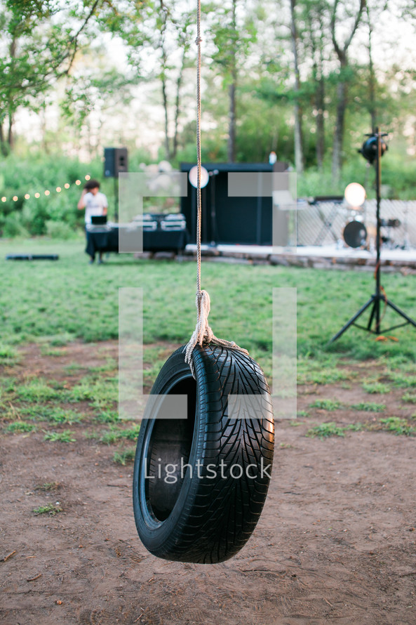 a tire swing by a concert stage 