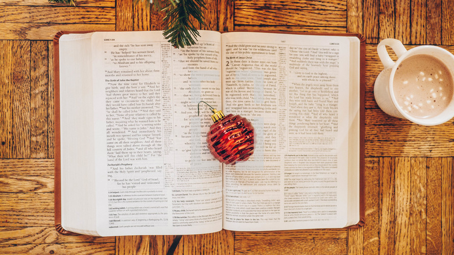 Christmas ornament on the pages of an open Bible 
