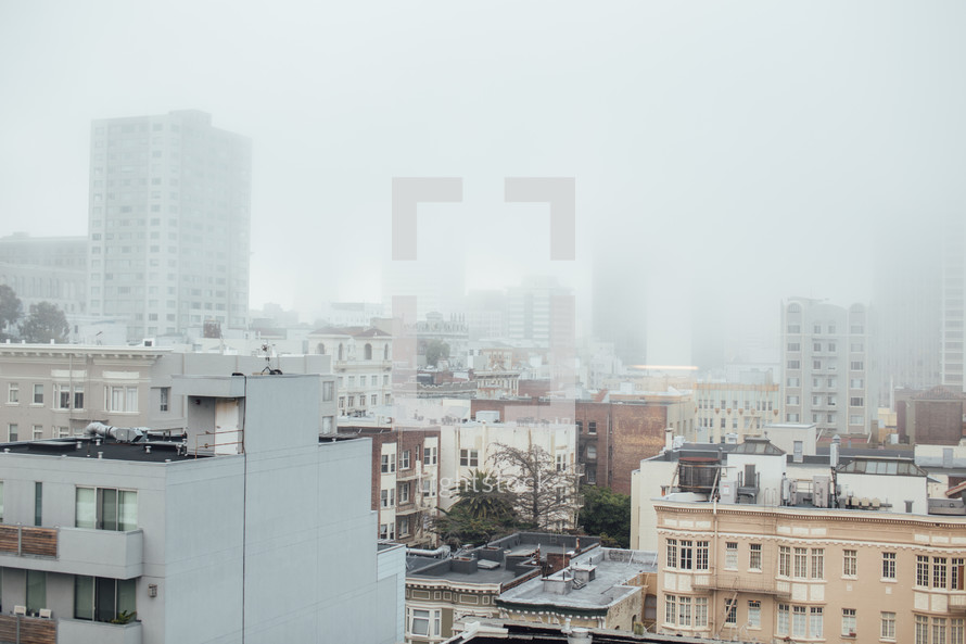fog over roofs in a city 