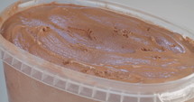 Chocolate ice cream with ice cream scoop in slow motion